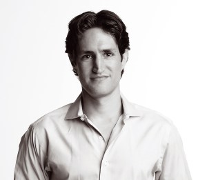 a black and white photo of a man in a dress shirt.