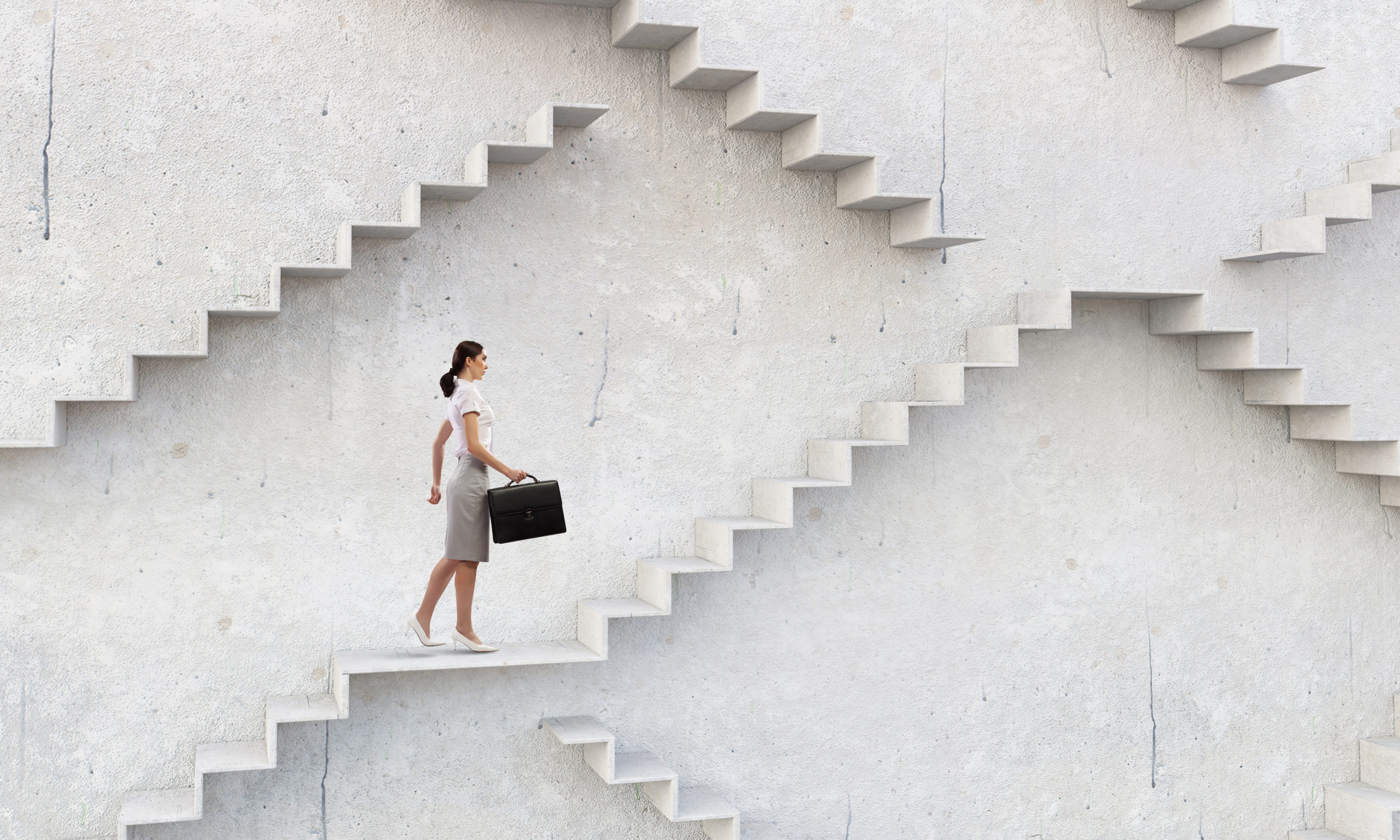 A businesswoman climbs a staircase as symbol of self-development and career growth.