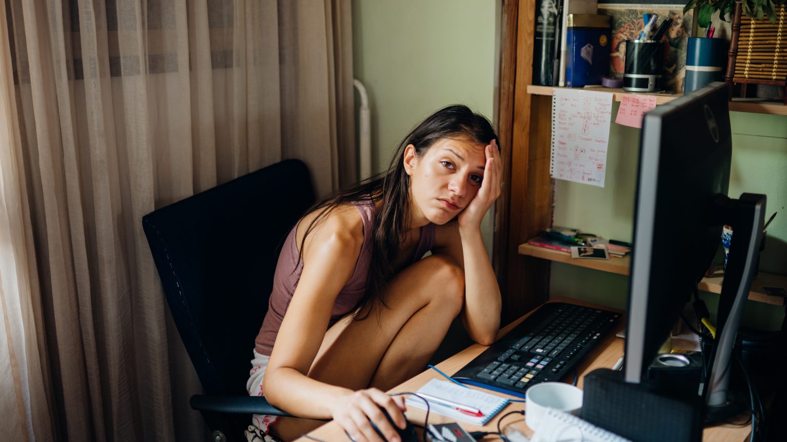 Stressed, depressed student working from her computer during the coronavirus pandemic.