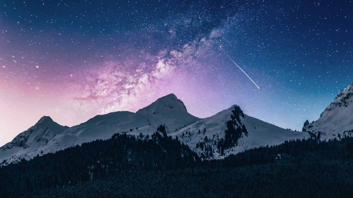 Shooting star over a mountain range