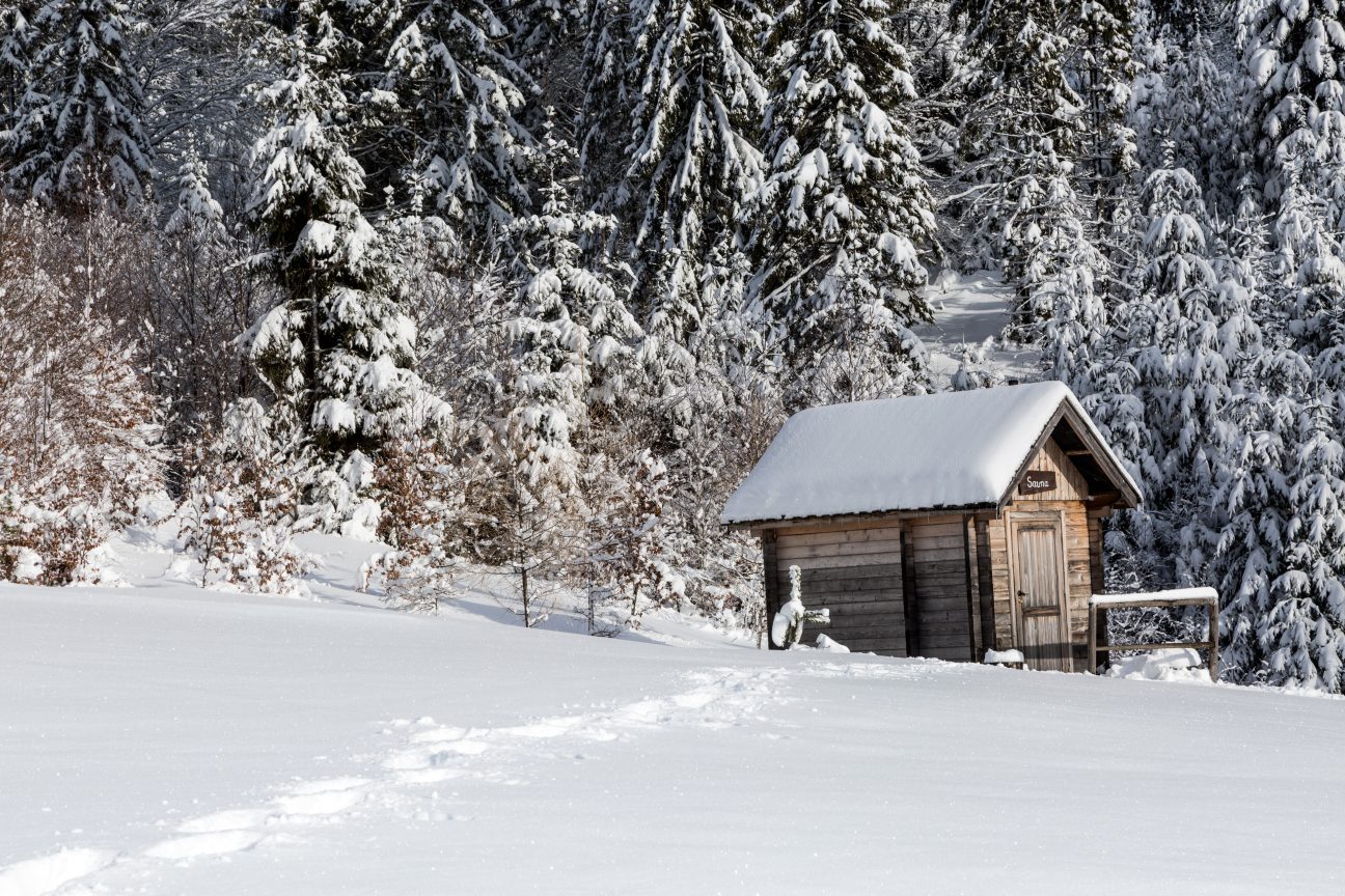 A wooden sauna in a Finnish winter forest