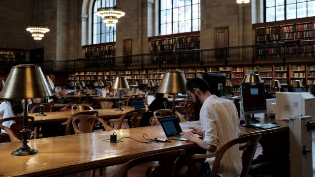 A man studies in a library.