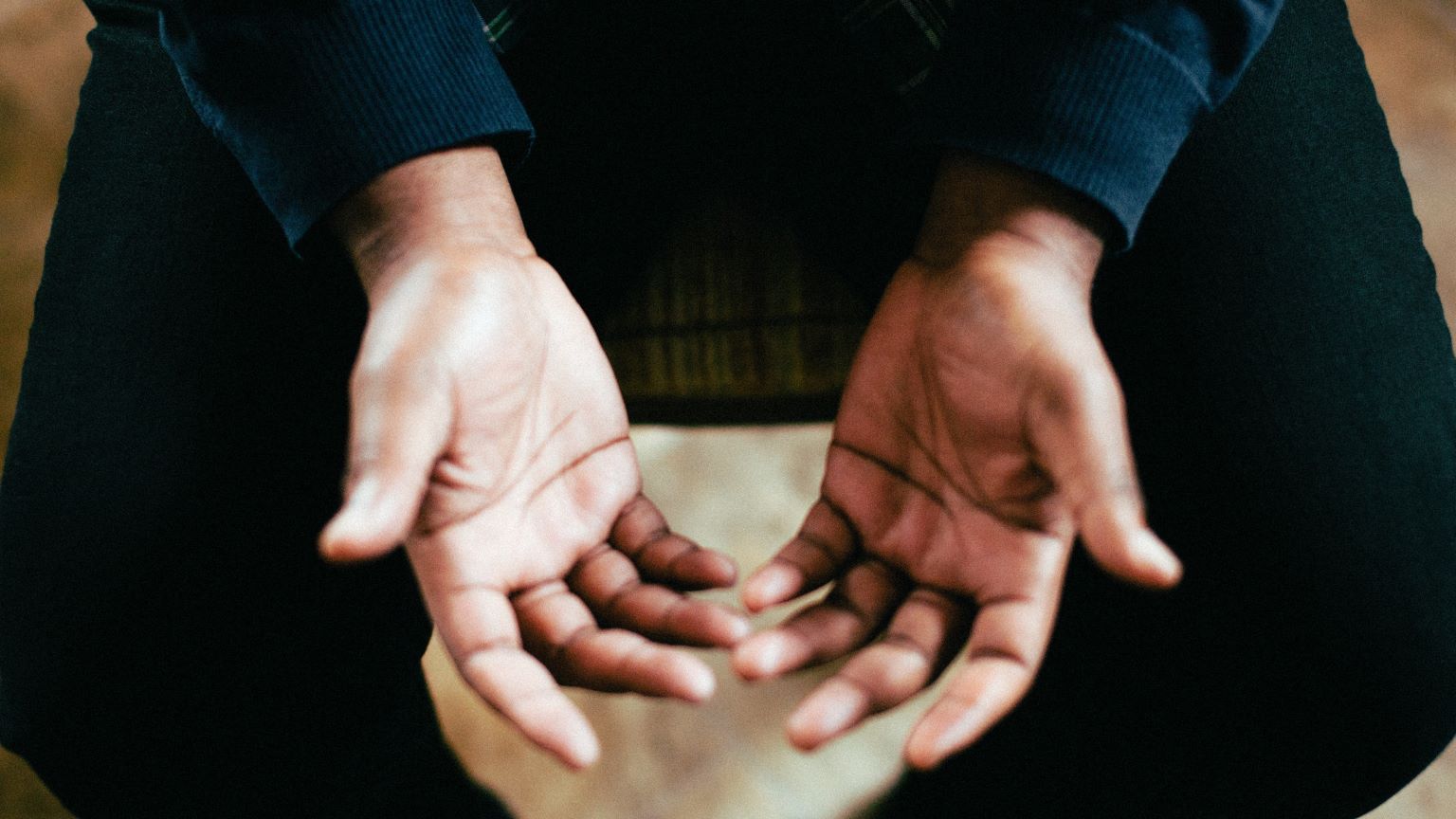 A close up of a man's hands palms facing up.
