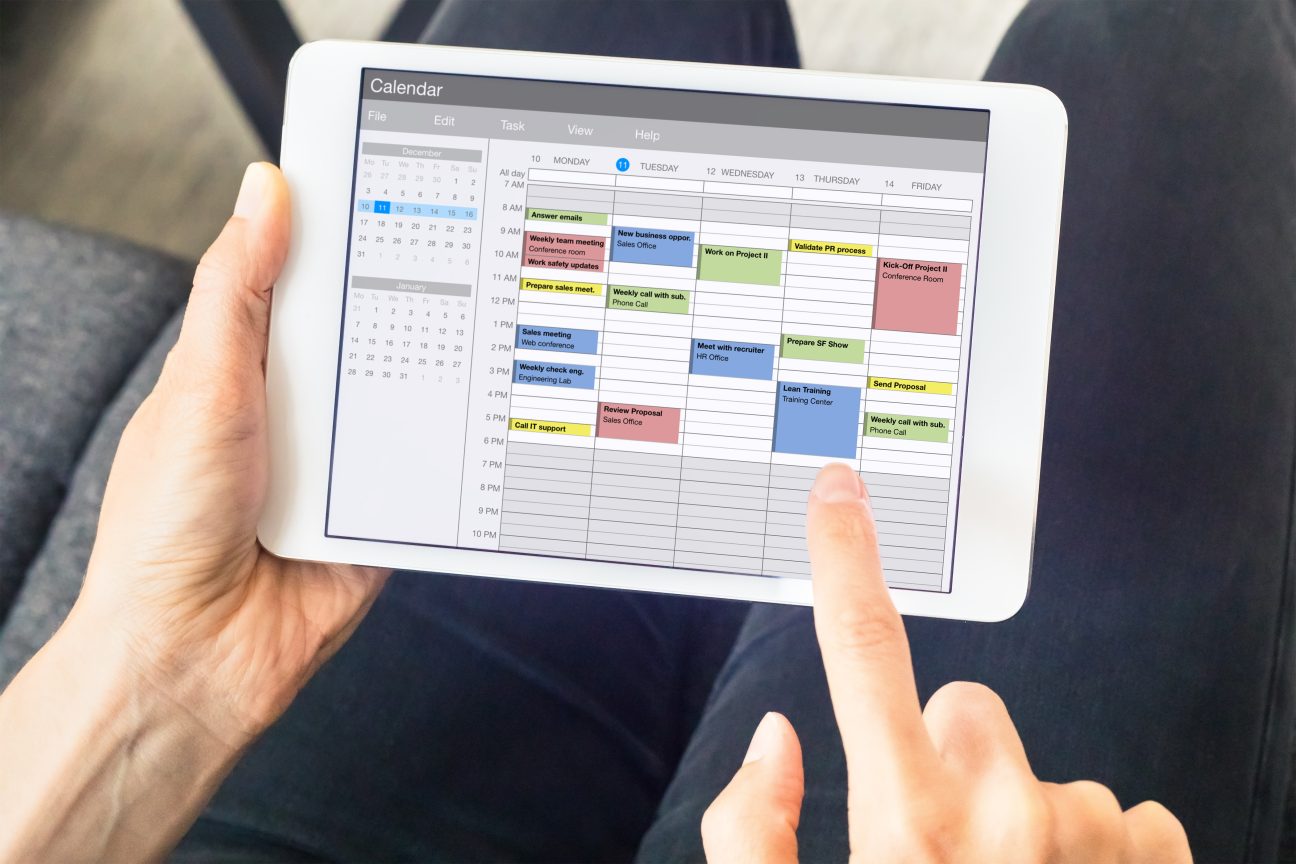 A man uses his calendar app to schedule his many, many activities.