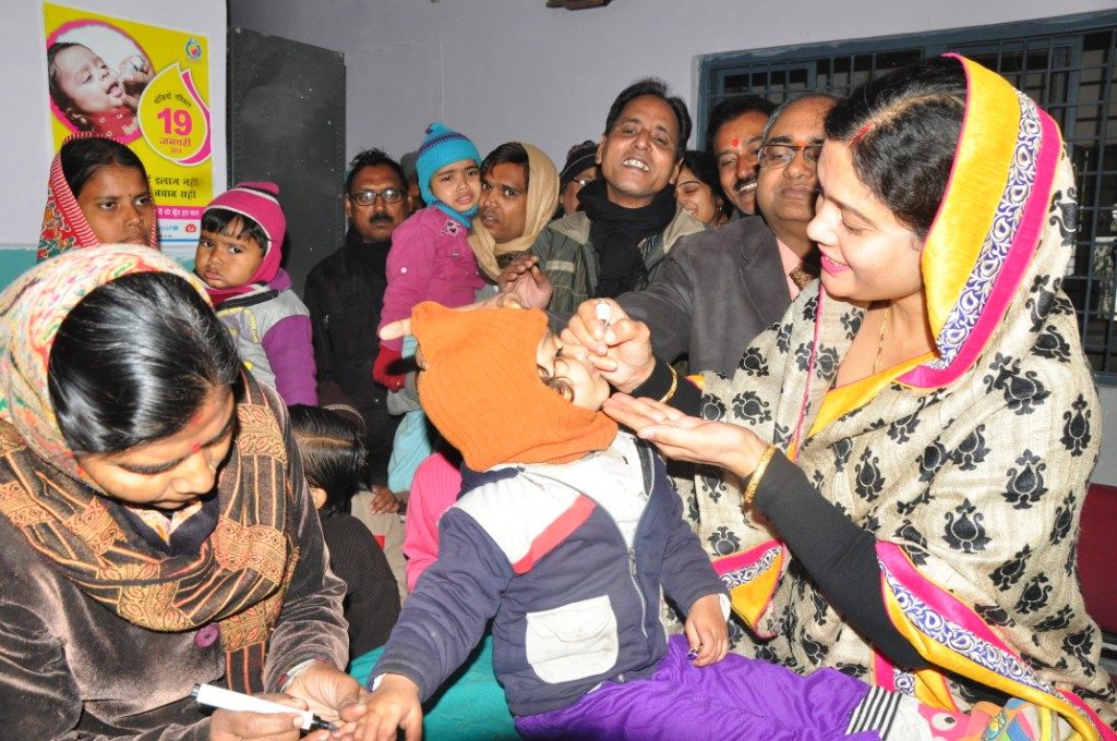 A child receives a polio vaccine drop in Gwalior, India.