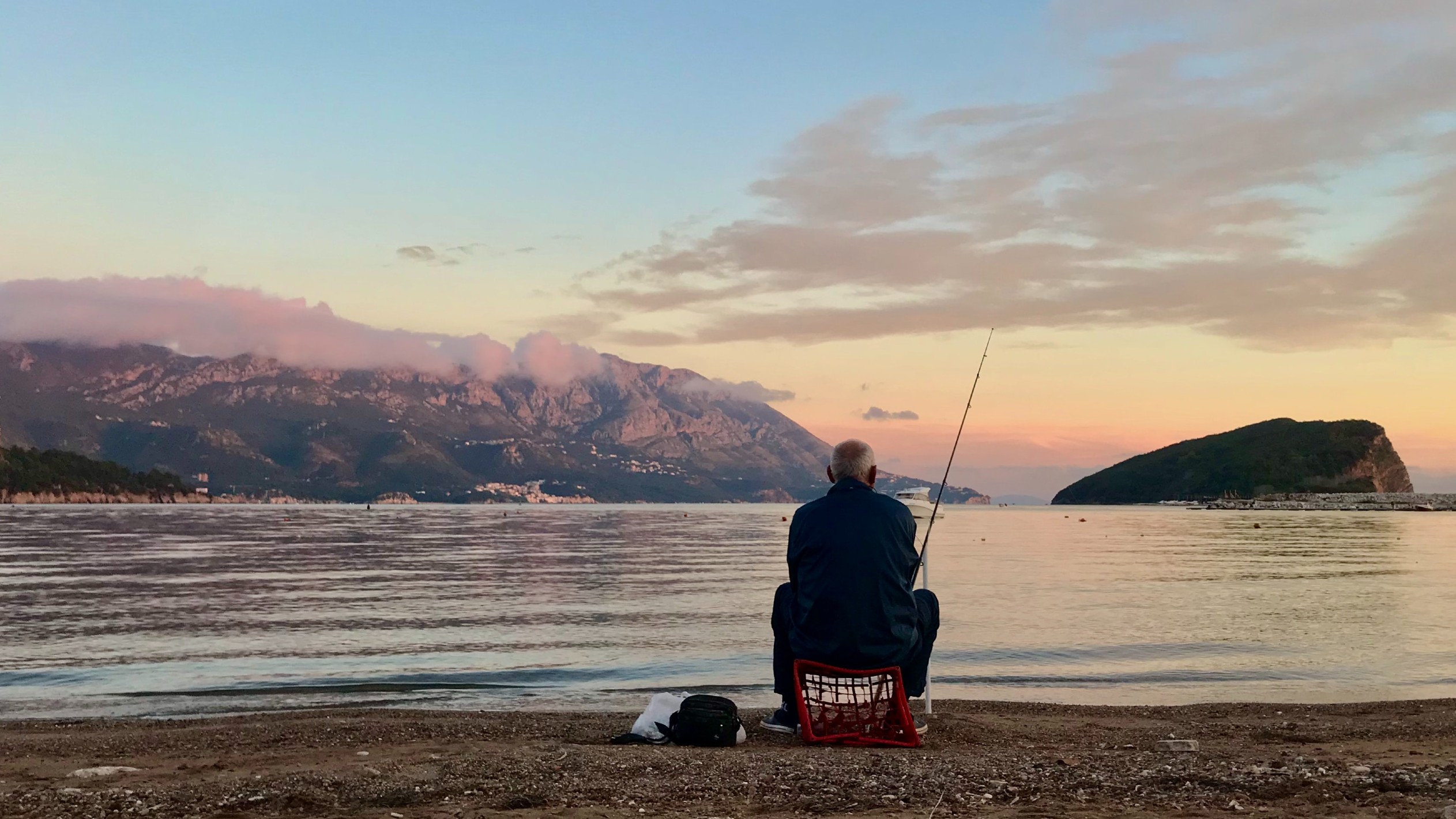 An old man fishes in Montenegro.