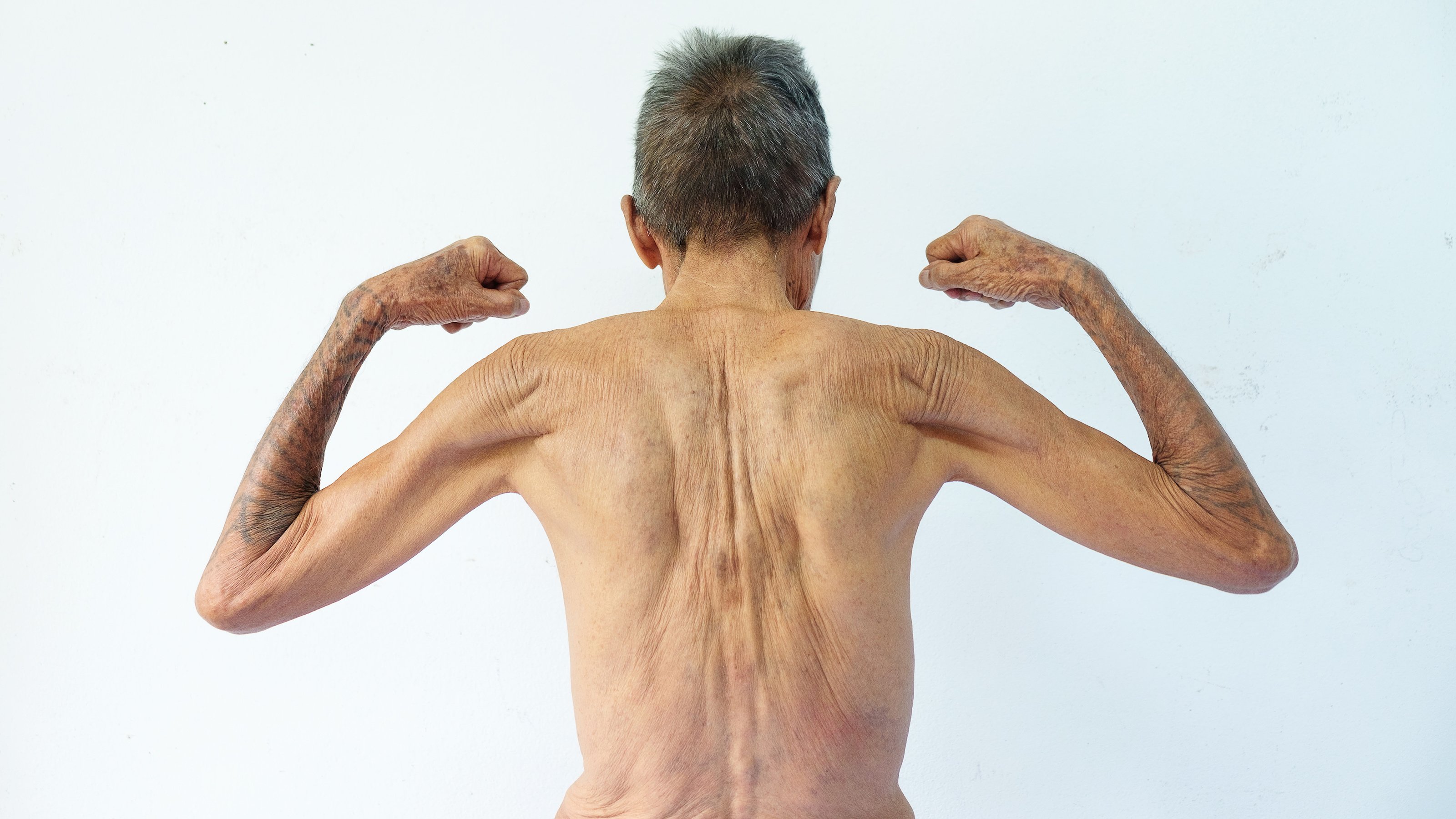 an old man flexing
