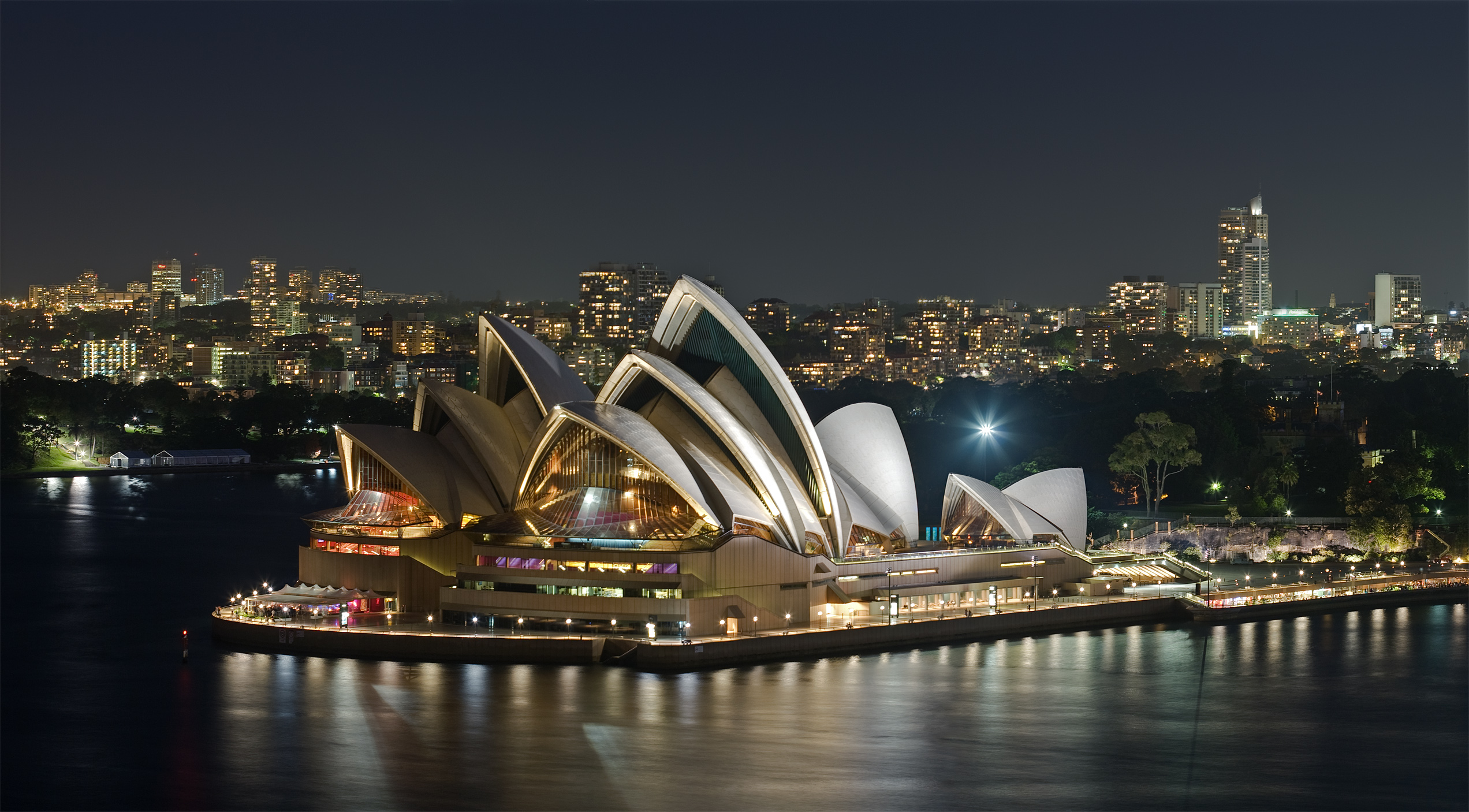 The Sydney Opera House as viewed from Sydney Harbour Bridge at night.