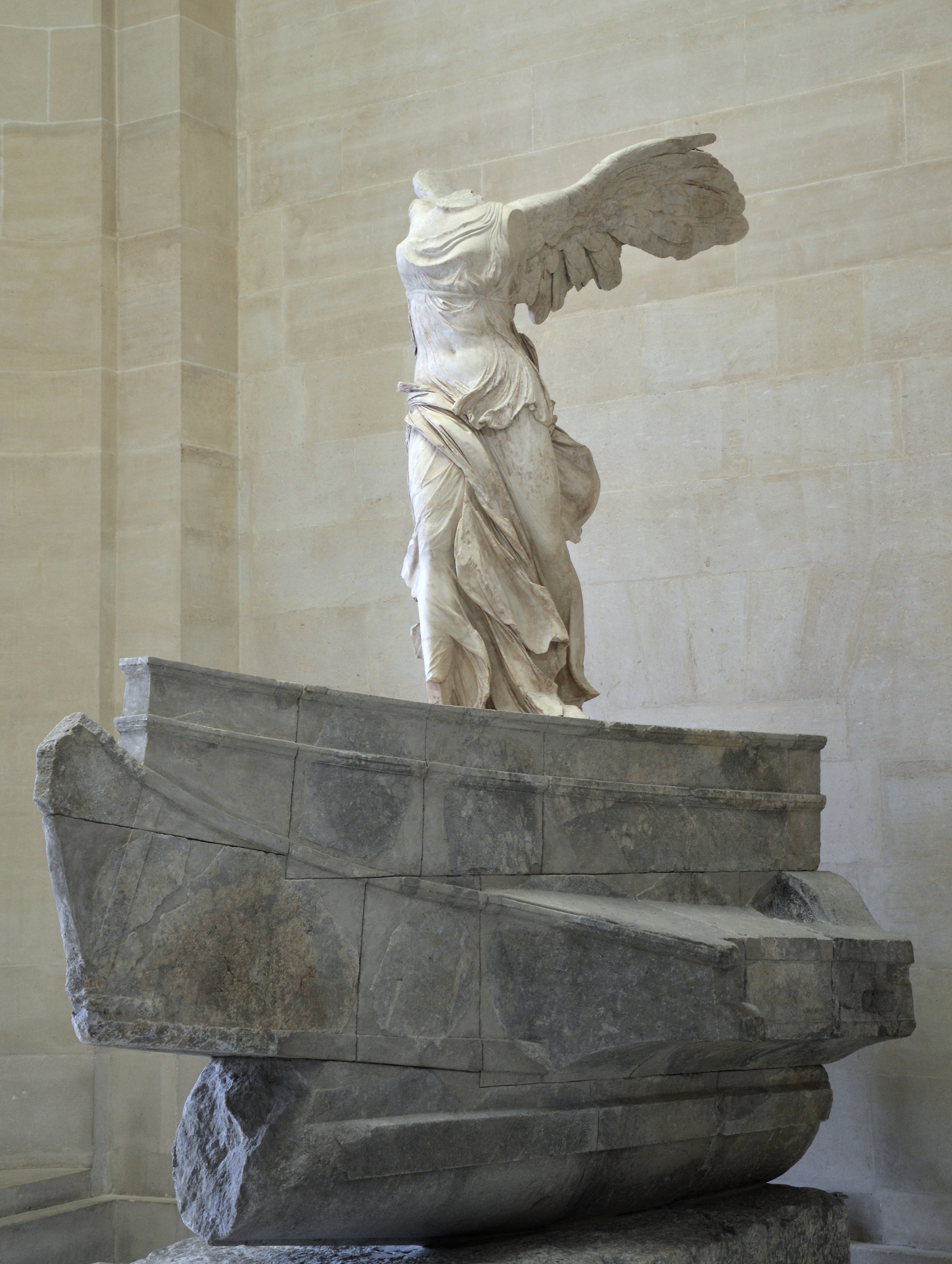 The Nike of Samothrace monument as seen in the Louvre Museum.