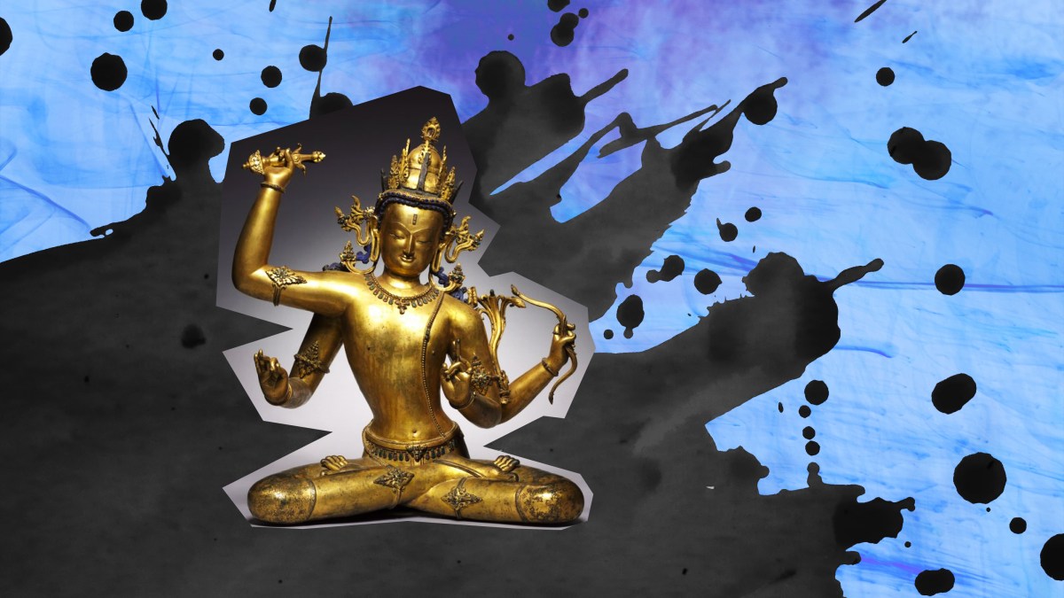 a golden statue of a person sitting in a lotus position.