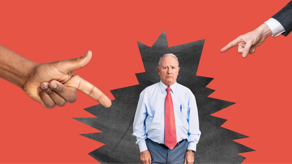 a man in a red tie and a hand pointing at him.