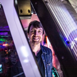 Jaroslav Švelch standing in an arcade.