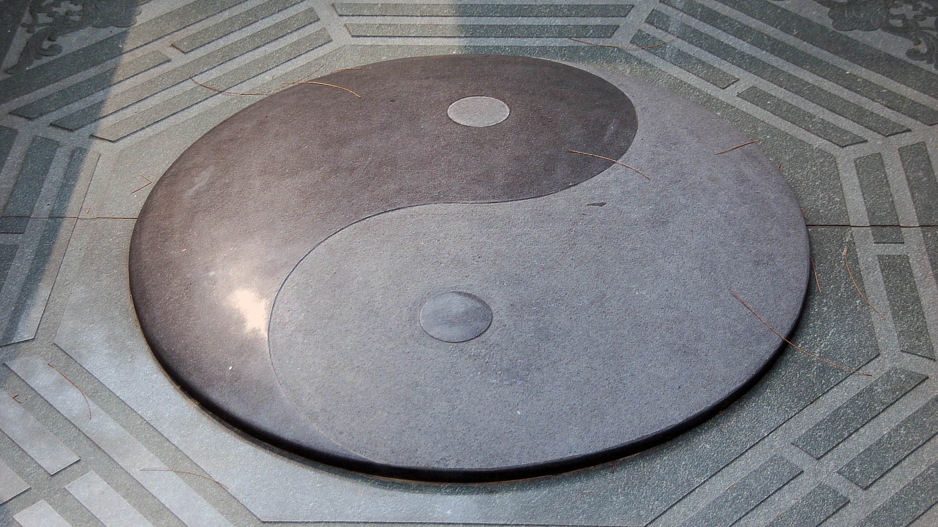 A yin and yang symbol carved in stone.