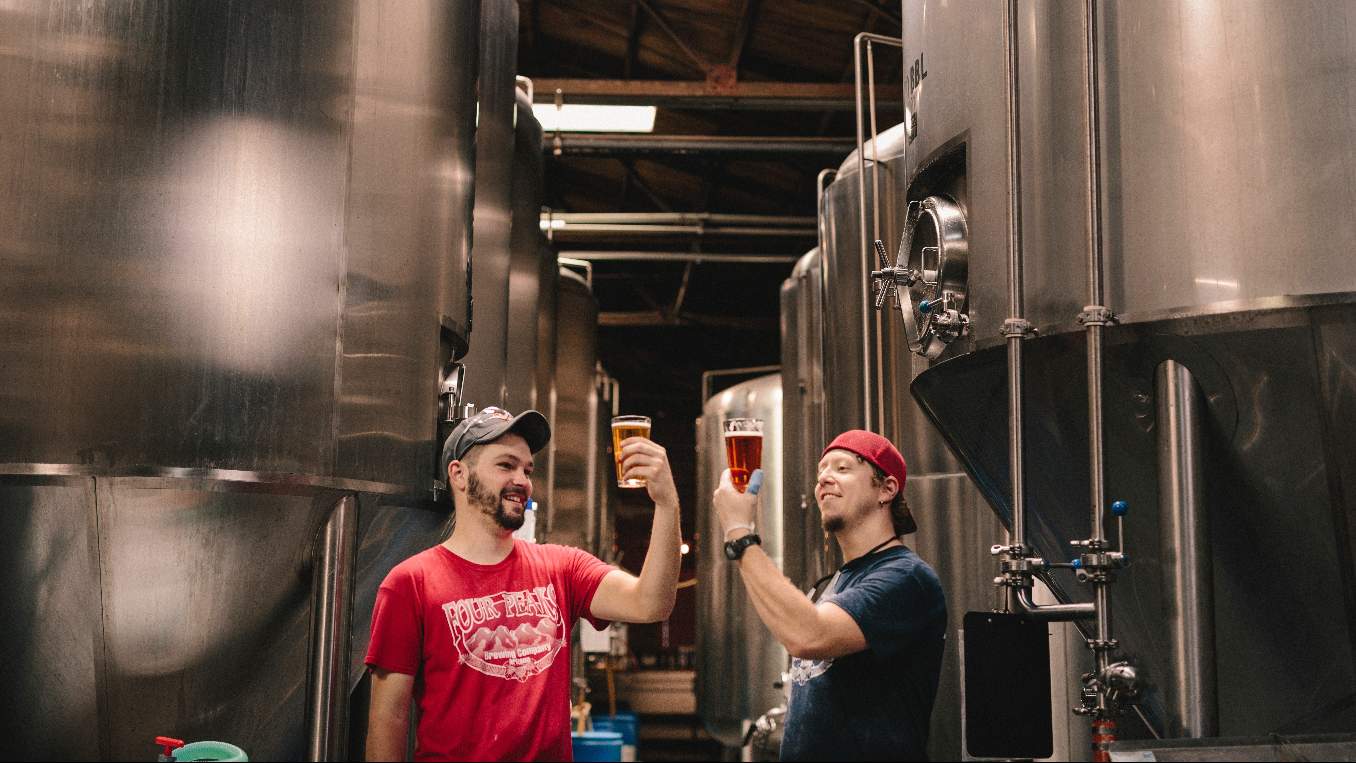 Two brewers analyze their latest beer batches.