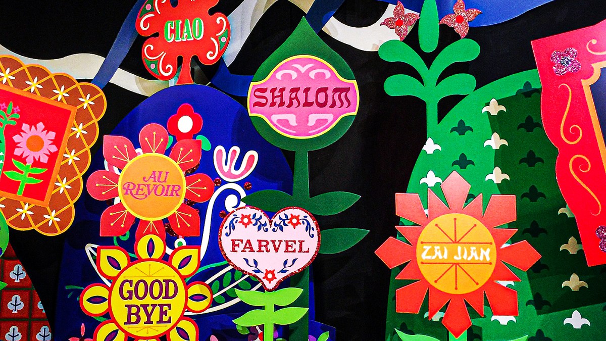 a bunch of colorful paper cut outs on a wall.