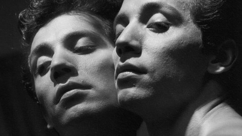 A black and white photo featuring two men engaged in a profound gaze.