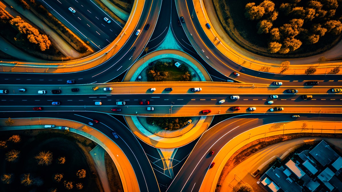 an aerial view of a highway intersection at night.