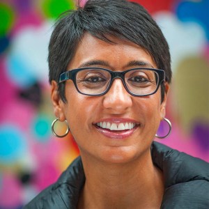 a woman wearing glasses and a black jacket.