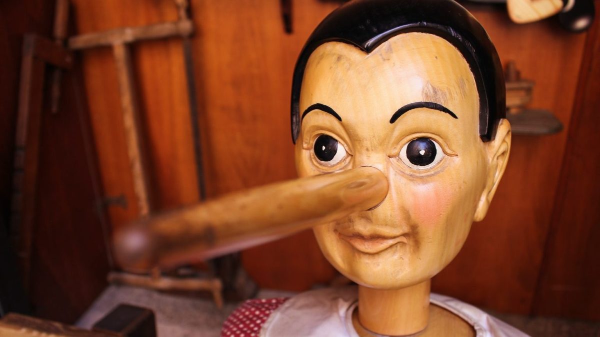 a wooden dummy with a wooden stick sticking out of it's mouth.