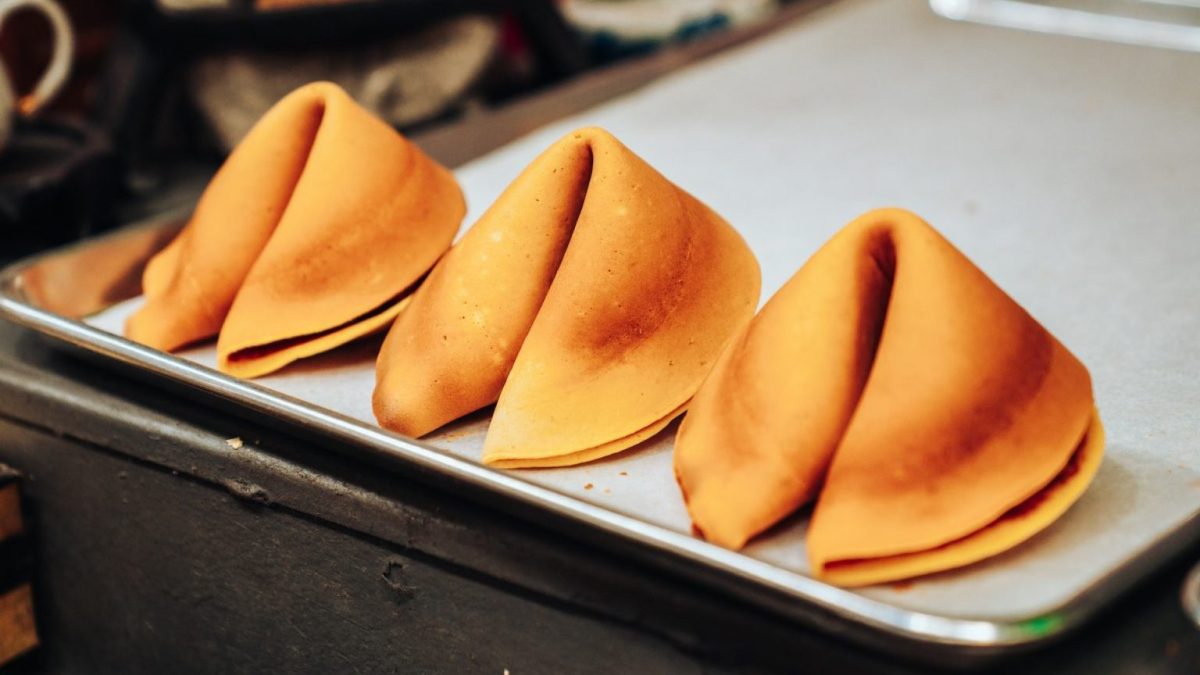 a metal tray topped with four pieces of food.