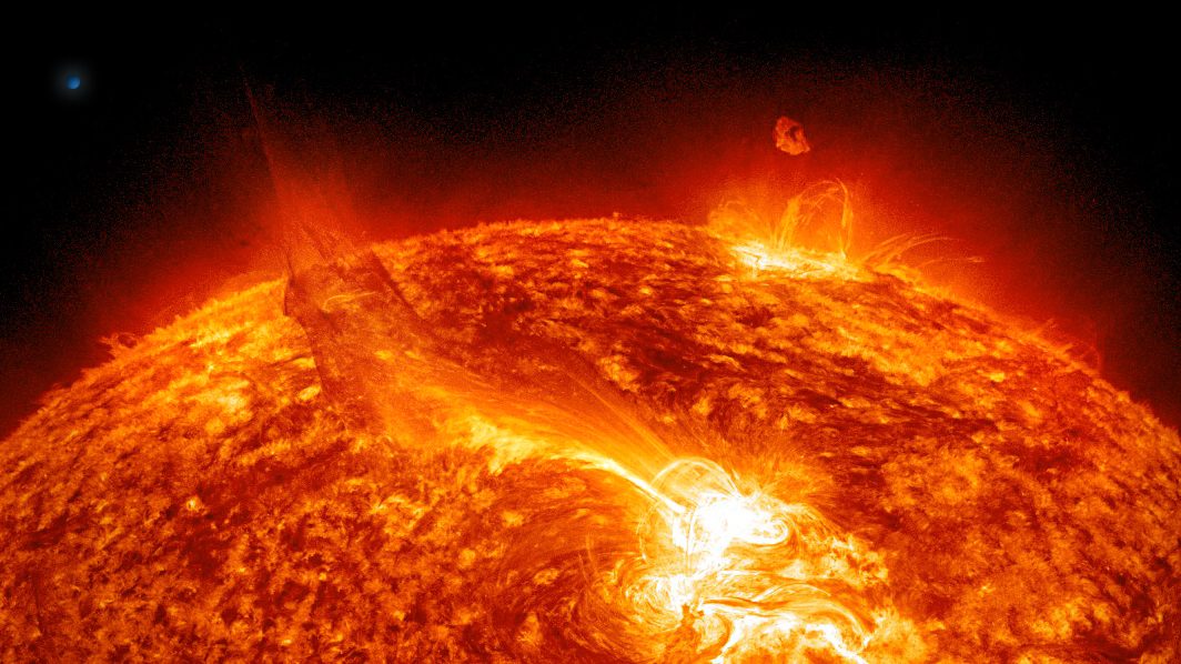 a close up of the sun with a black background showing a solar flare.