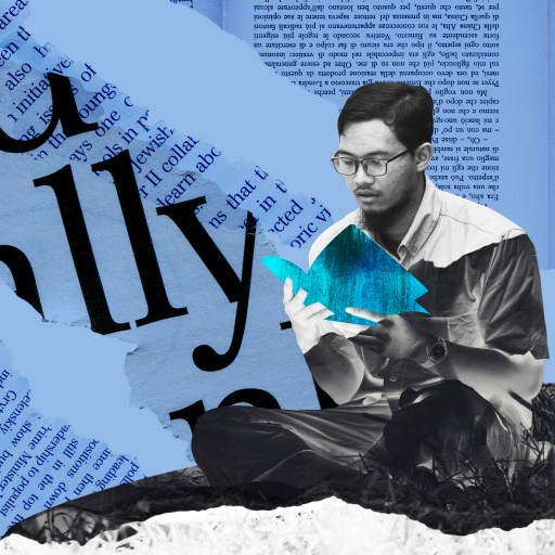 a man sitting on top of a pile of paper.