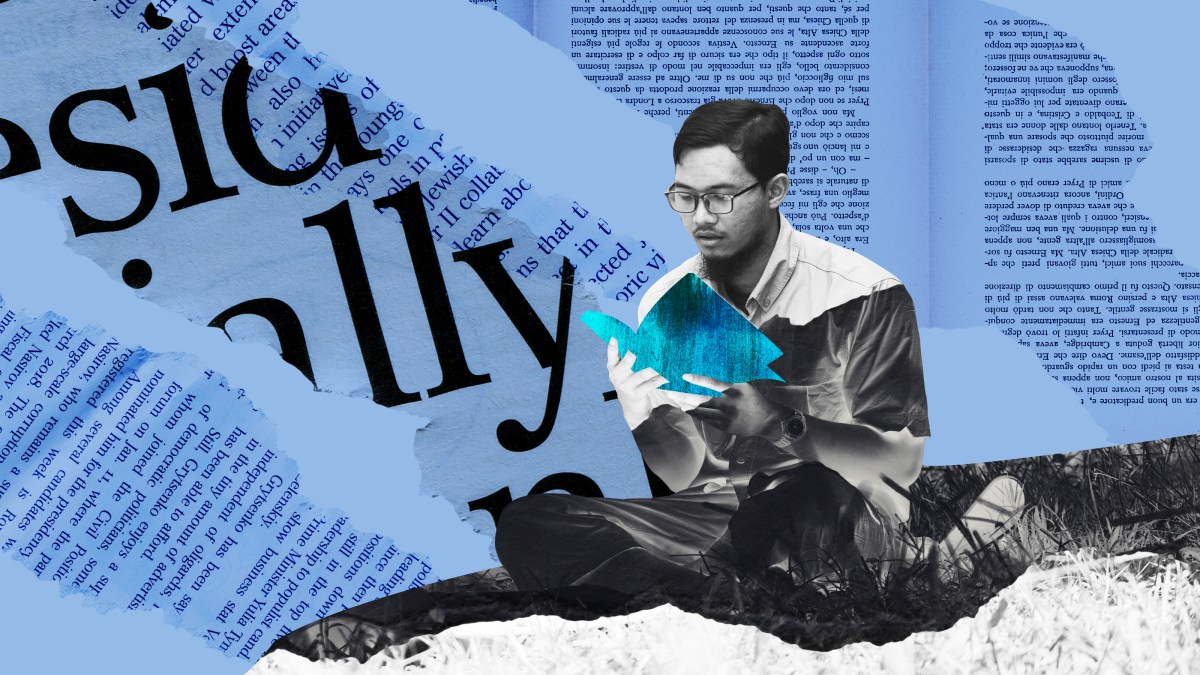 a man sitting on top of a pile of paper.