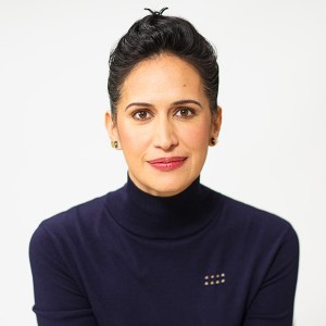 Priya Parker in a blue turtle neck sweater