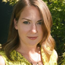 a close up of a person wearing a yellow shirt.