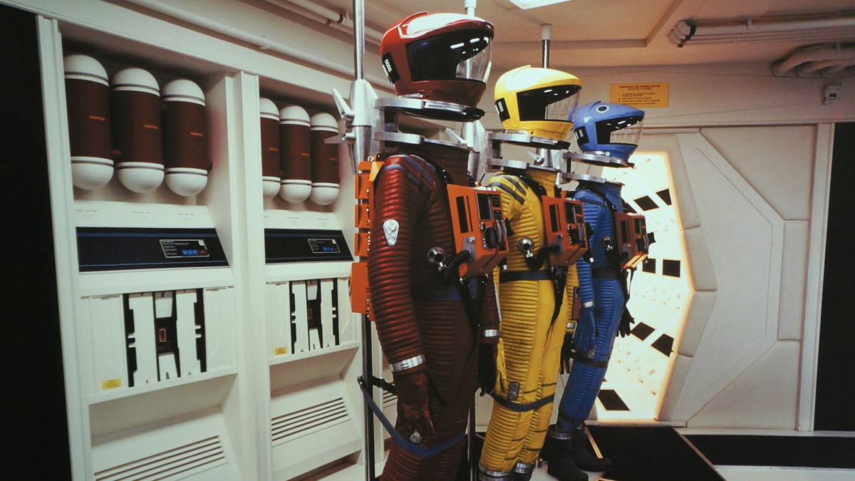 a room with a bunch of different types of helmets on display.