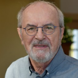 a close up of a person wearing glasses.