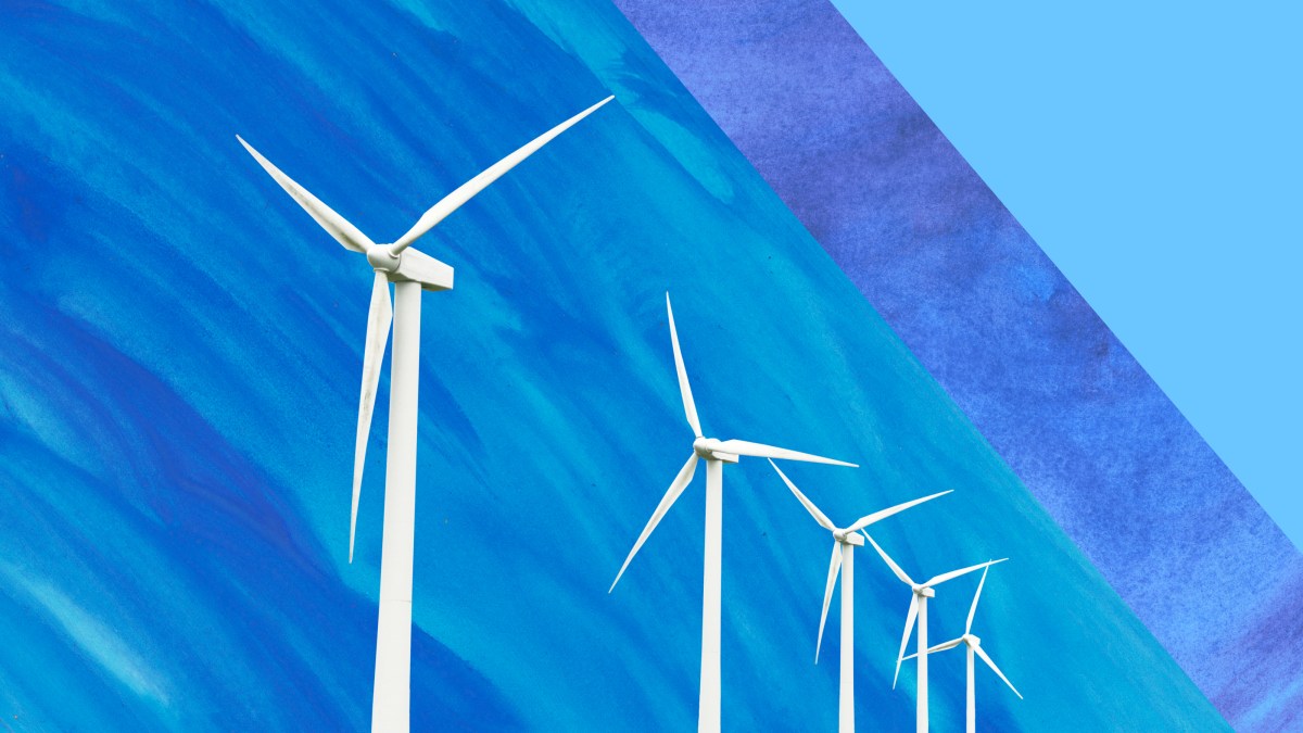 a row of wind turbines against a blue sky.