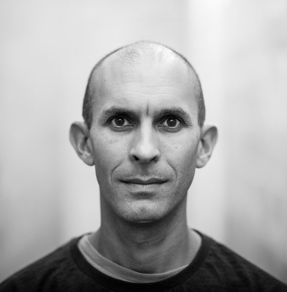 a black and white photo of a man with a bald head.