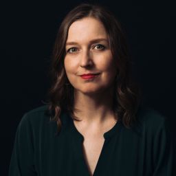 a woman with long hair wearing a black shirt.