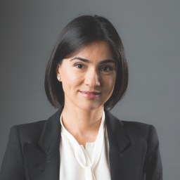 a woman wearing a black jacket and a white shirt.