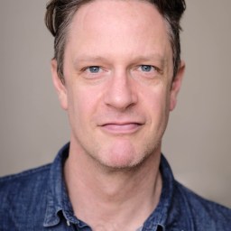 a close up of a person wearing a blue shirt.