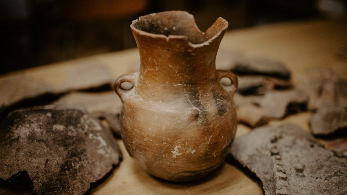 a vase sitting on top of a wooden table.