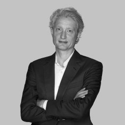 a black and white photo of a man in a suit.