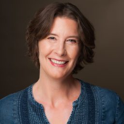 a woman with short hair smiling for the camera.
