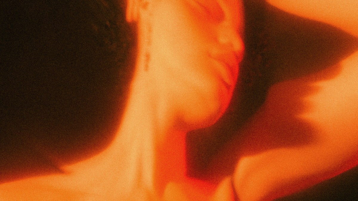 A woman experiencing a near-death event with her head uplifted.