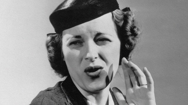 A hat-wearing woman in a black and white photo.