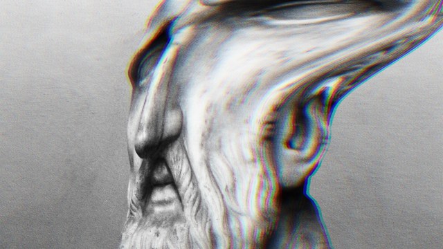 A stoic man with a beard in a black and white photo.