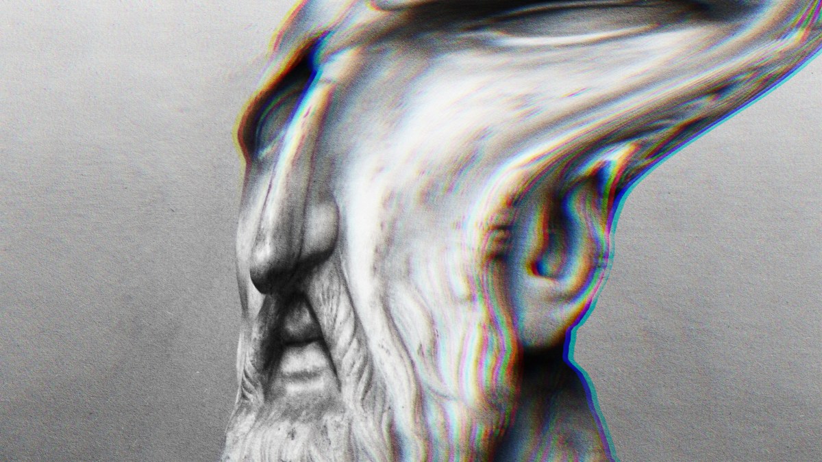 A stoic man with a beard in a black and white photo.