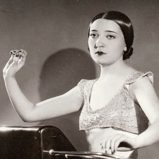 An old photo of a woman holding a theremin.