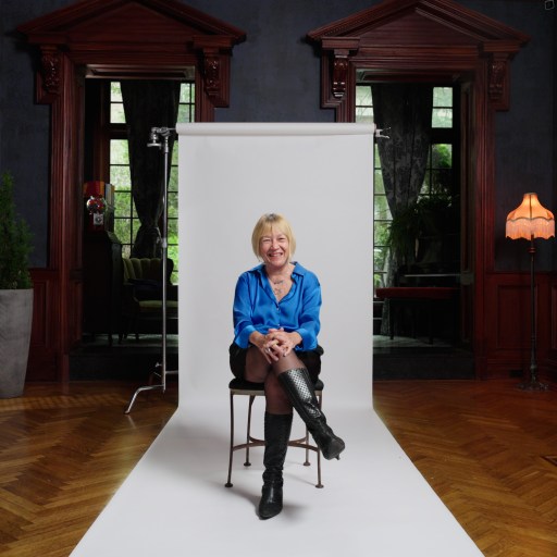 A woman sitting on a chair in a room.