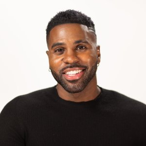 A black man smiling for the camera.