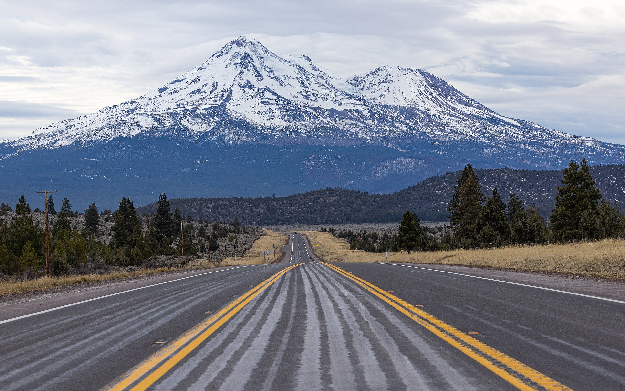 A road with a mountain in the background.
