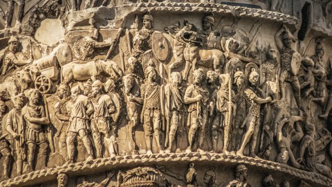 A statue of a man on a column, reflecting the history of pants.