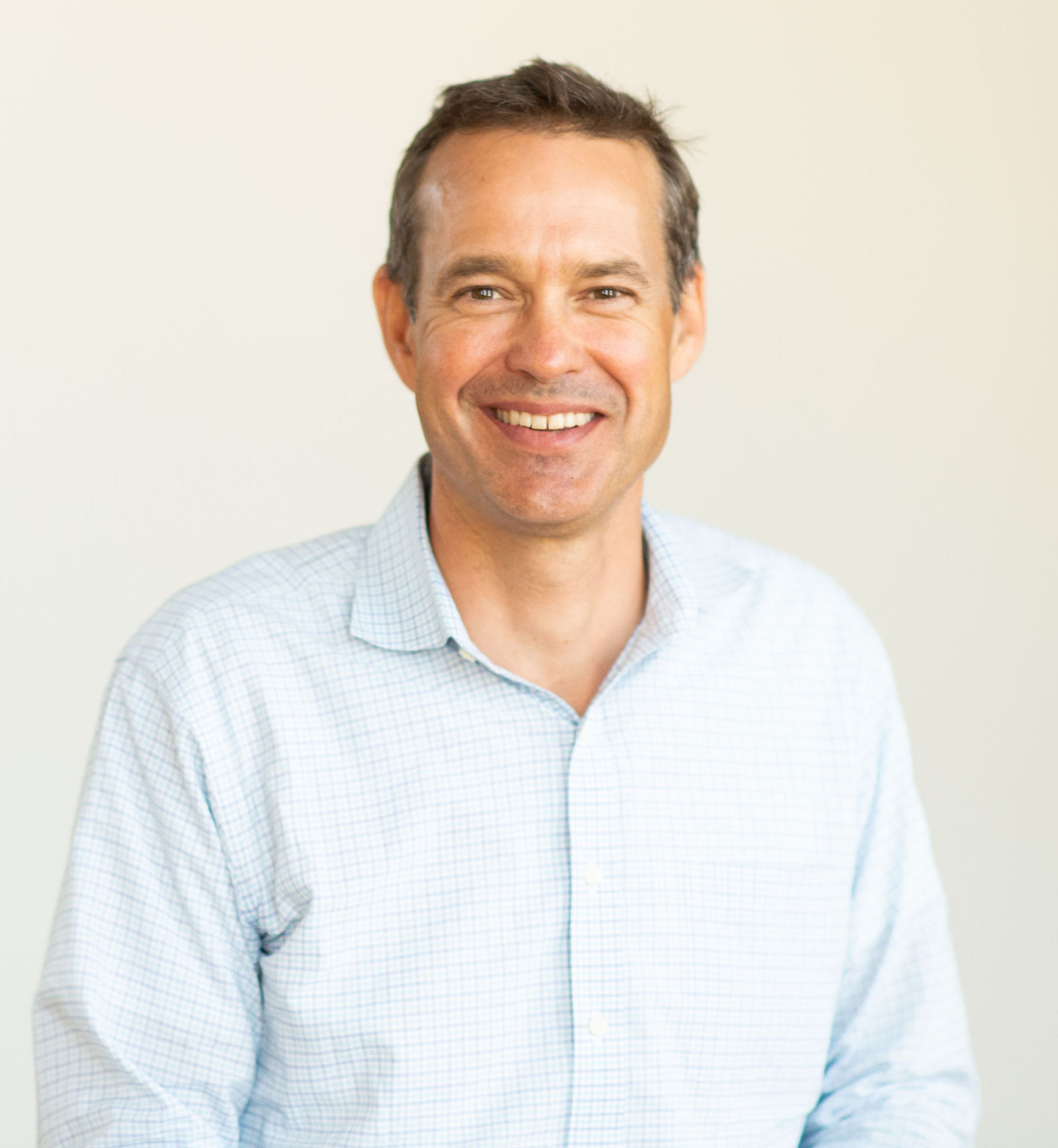 A smiling man in a blue shirt.