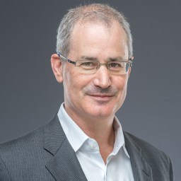 A man in glasses is posing for a photo.